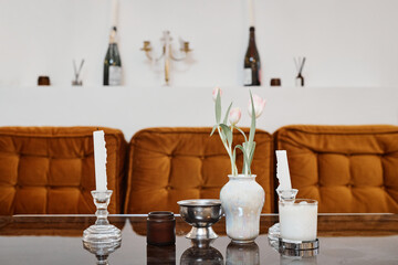 Minimal background image of luxury seating area with flower vase and decor on glass table, copy space