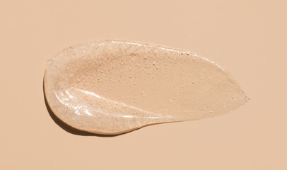 cosmetic smears scrub peeling cream texture on a beige background
