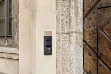 Modern intercom on a stoned facade. Secure password on keyboard for opening home house door