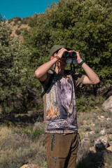 Hunter looking through binoculars