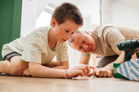 Father and son choosing screws at home