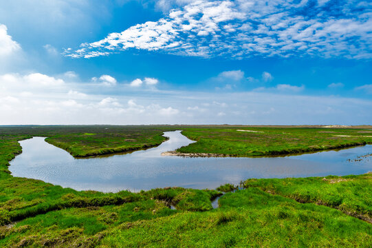 Germany, Schleswig-Holstein, St. Peter-Ording, Sky over salt marshes at high tide