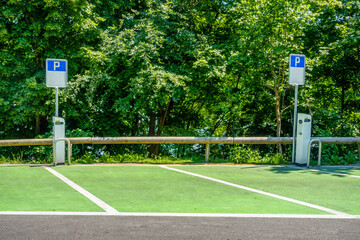 Electric car charging station near trees on sunny day