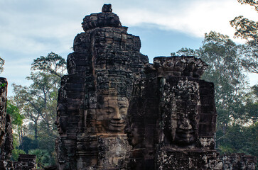 The bayon temple smiling stone faces showing on a sunny day in angkor thom, siem reap, cambodia