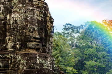 Fototapeta premium The bayon temple smiling stone faces showing on a sunny day in angkor thom, siem reap, cambodia