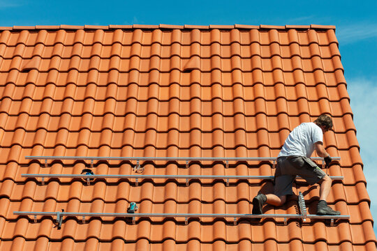 Engineer installing metal structure on house roof