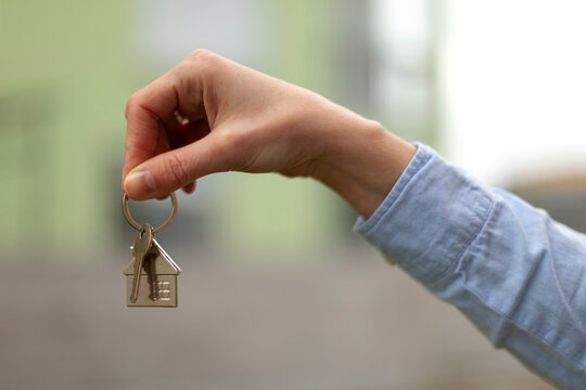 Real estate agent holding house key chain