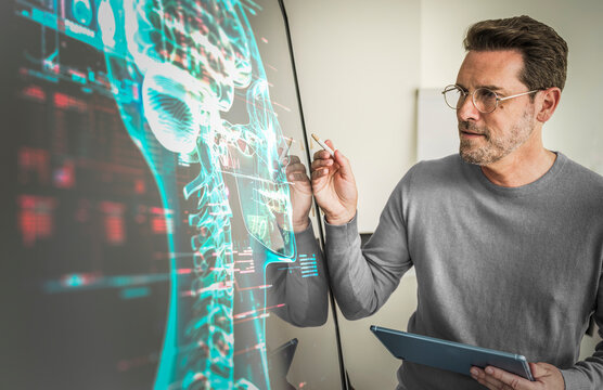 Scientist analyzing human brain on computer monitor in laboratory
