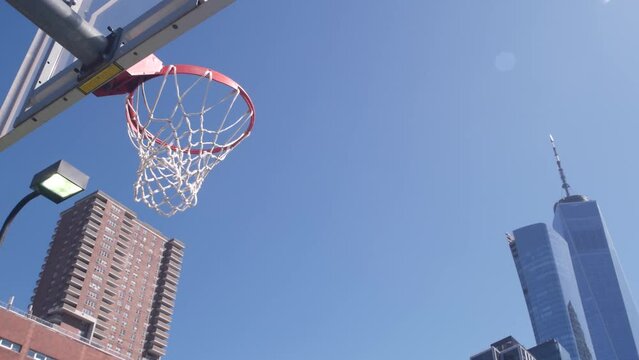 New York City World Trade Center skyscraper tower building, Manhattan Downtown Financial district, USA. Hudson River Park basketball court. Basket ball hoop and blackboard. Outdoor streetball sport.