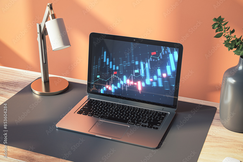 Poster close up of laptop on office desk with lamp and glowing blue candlestick forex chart on screen. fina