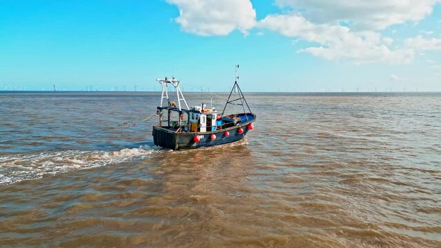 Fishing Boat, trawler, just offshore fishing, trawling with the coast, coastline visible