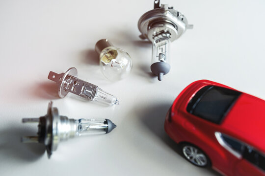 different automotive bulbs h1 h4 h7 with small toy car. Car repair conecpt