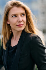 Portrait of a Stylish Business Blonde Posing on Terrace in Urban Cityscape.