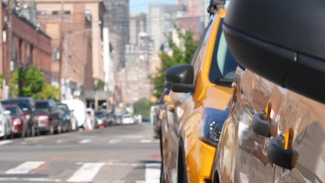 New York City. Row of yellow Taxi cars on street, Queens. Many taxi cabs on avenue, Long Island, LIC. Medallion taxicab and Manhattan Midtown urban skyline cityscape. High-rise building architecture.