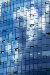 A building with numerous windows set against a backdrop of a clear blue sky
