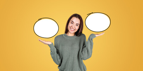 A woman standing with open hands, presenting two blank speech bu