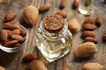 A bottle of almond oil on a table - ingredient for cosmetics