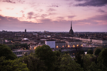 Obraz premium Purple panoramic sunset view of Turin skyline and Mole Antonelliana from Church of Santa Maria del Monte dei Cappuccini