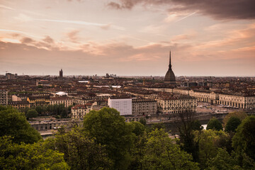 Fototapeta premium Orange sunset view of Turin and Mole Antonelliana from Church of Santa Maria del Monte dei Cappuccini