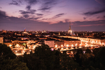 Parple panoramic night view of Turin skyline and Mole Antonelliana from Church of Santa Maria del...