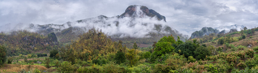 Rural panoramic landscape of picturesque agricultural mountain valley with low clouds in Chiang Dao countryside, Chiang Mai, Thailand	
