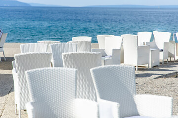 White Wicker Chairs on a Beachside Patio in town Opatija