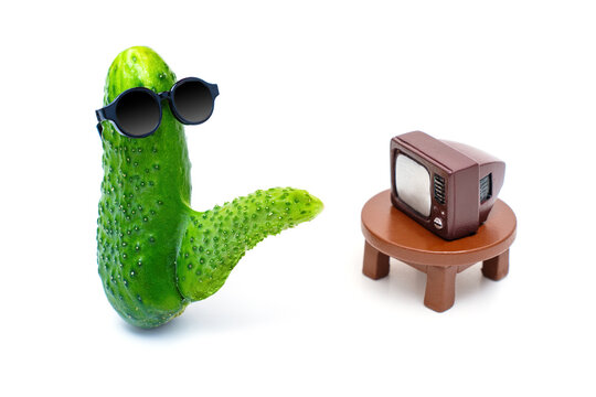 Cucumber in Sunglasses with Phallic Growth in Erection State Watching TV