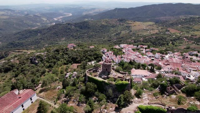 Aerial view of a mountain village with castle, greenery, medieval architecture and scenic panoramas. Castillo del Aguila, Gaucin pueblo, Malaga Spain