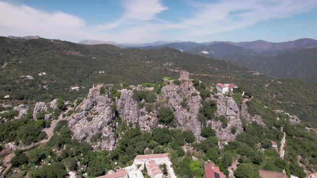 Aerial image of a mountain village with an ancient castle in a picturesque landscape, Castillo del Aguila, Gaucin pueblo, Malaga Spain