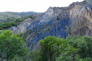 Rock containing blue pigment colored the mountains. Forest in the foreground