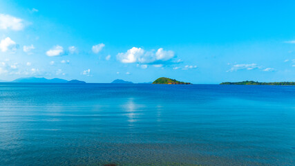 Ocean background and sea water and clear sky. For summer vacation ideas The nature of the beach and summer sea with the sun shining on the sea sparkling against the blue sky.	