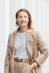 Portrait of young adult businesswoman in formal dress outdoors. Happy confident business woman...