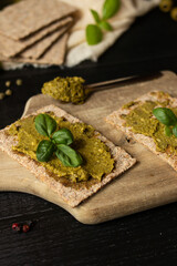 Fresh pesto sauce. on a dark background. ingredients