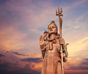 The huge Shiva statue Mangal Mahadev is a 33 m art piece in Ganga talao temple on the blue evening...