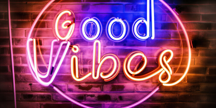 Vibrant Neon Sign Displaying "Good Vibes" Against a Brick Wall Background.