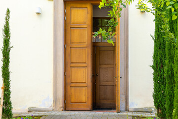 door is open and the door frame is made of wood