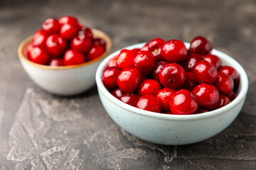 Cherries. Fresh ripe cherries with leaves on a textured wooden background. Fresh sweet organic cherry pile. Berries and fruits. Vegan. Healthy eating. Place for text. Copy space
