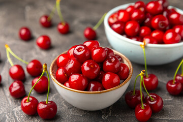 Cherries. Fresh ripe cherries with leaves on a textured wooden background. Fresh sweet organic cherry pile. Berries and fruits. Vegan. Healthy eating. Place for text. Copy space