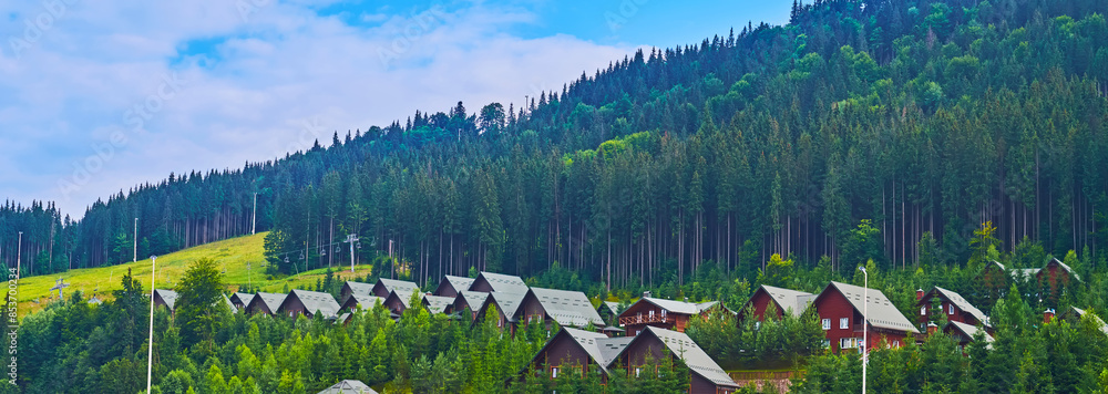 Sticker Panorama with tourist houses and conifer forests, Bukovel, Carpathians, Ukraine