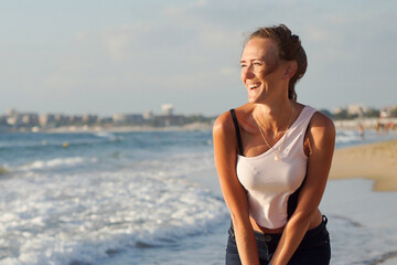 The girl is happy on the seashore, vacation and fun.