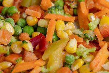 a mixture of quick-frozen corn, peas, peppers, and carrots