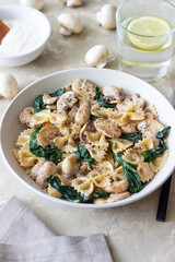 Farfalle pasta with mushrooms and spinach. Healthy eating. Vegetarian food.