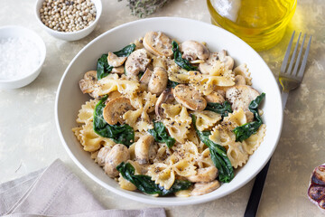Farfalle pasta with mushrooms and spinach. Healthy eating. Vegetarian food.
