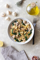 Farfalle pasta with mushrooms and spinach. Healthy eating. Vegetarian food.