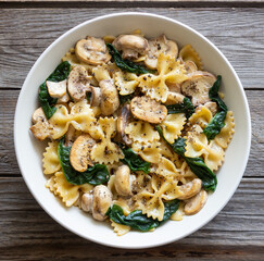 Farfalle pasta with mushrooms and spinach. Healthy eating. Vegetarian food.