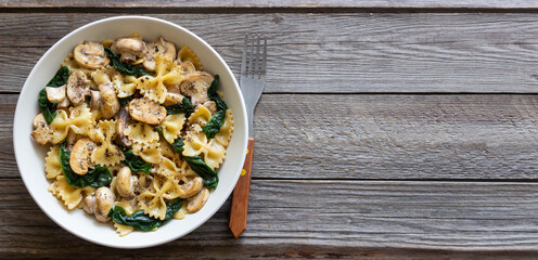 Farfalle pasta with mushrooms and spinach. Healthy eating. Vegetarian food.