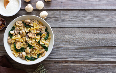 Farfalle pasta with mushrooms and spinach. Healthy eating. Vegetarian food.