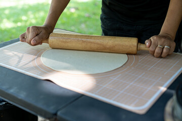 Preparing dough for making pizza