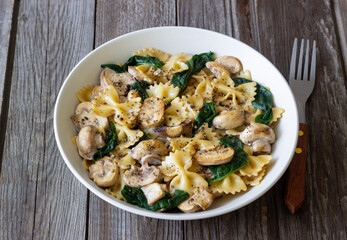 Farfalle pasta with mushrooms and spinach. Healthy eating. Vegetarian food.