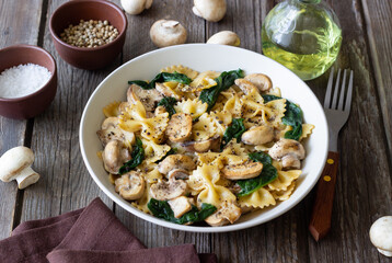 Farfalle pasta with mushrooms and spinach. Healthy eating. Vegetarian food.